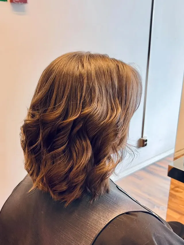 Mellanlångt brunt hår med naturliga lockar och styling